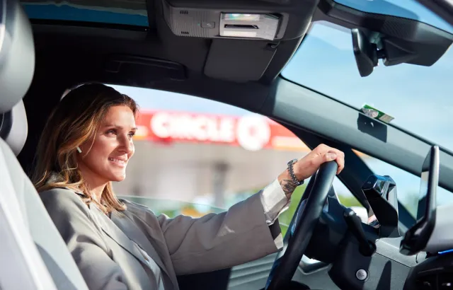 Business woman sitting in her car outside a Circle K station